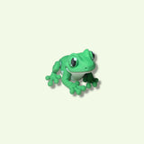 Green frog toy on a beige background